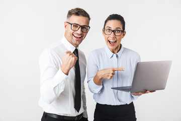 Business colleagues couple isolated over white wall background using laptop computer.