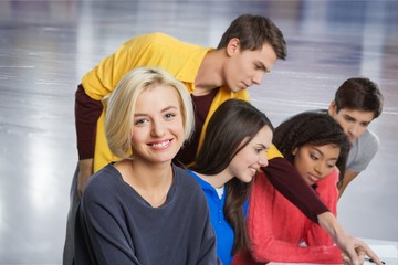 Portrait of a cute young student girl holding colorful notebooks