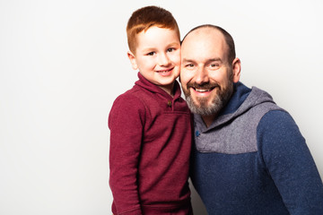 cheerful redhead father and son and smiling at camera isolated on white