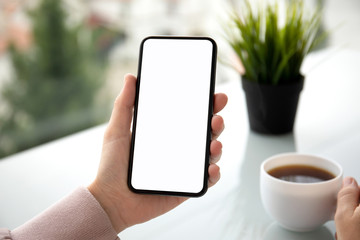 female hands holding phone with isolated screen in summer cafe