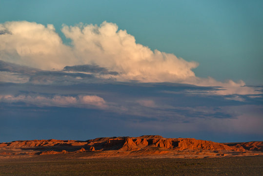 Sunset and storm clouds over Flaming Cliffs, Gobi Desert, Bulgan, Mongolia
