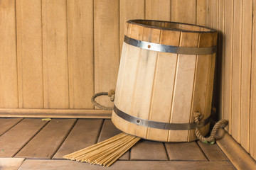 Wooden bucket with bamboo broom in the sauna