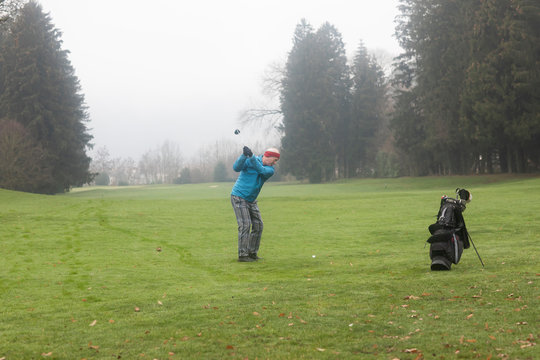 Man playing golf in the winter, Germany