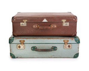 Two old vintage suitcases on white background, contains clipping path