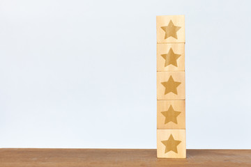 Wooden cube five star on white background. Service rating, satisfaction concept