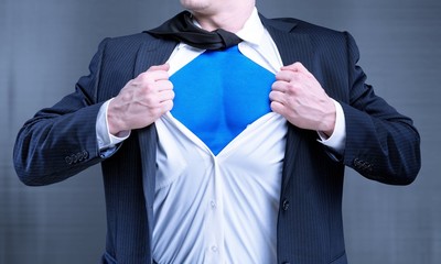 Businessman tears shirt on himself to show that he is Superman