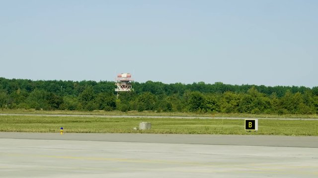 Rotating radar. Wide angle view of glide path beacon and runway. 4K