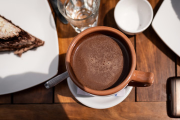 cup of coffee and chocolate cookies on wooden table