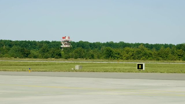 Rotating radar. Wide angle view of glide path beacon and runway. 4K