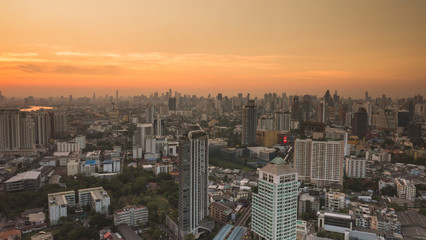 Naklejka na ściany i meble Business area in Bangkok, Thailand, showing buildings and traffic in sunset