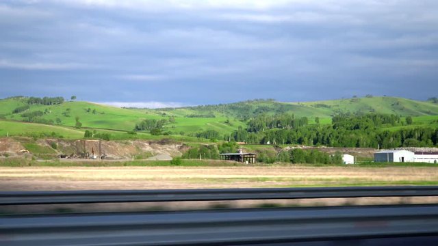 The highway in the mountain area. Movement of the camera. 4K. Sky and clouds.