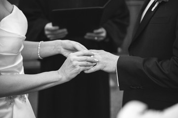 A bride and groom exchange rings 
