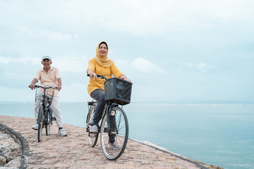 old couple ride bicycle together
