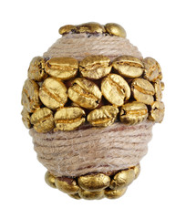 Easter egg made from golden coffee beans and rope isolated