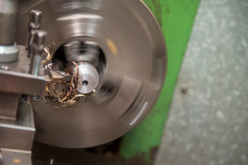 The lathe machine cutting the steel shaft . with the cutting tool.Metal working in factory.