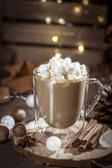 Hot coffee with milk in transparent glass with marshmallow