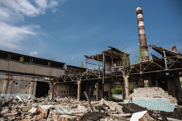 Fototapeta premium Ruined concrete industrial building after earthquake destruction or war