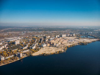 Aerial view of city with buildings on bay of big river with blue water, drone photo