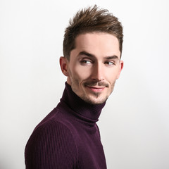 Obraz premium Handsome young elegant man in violet golf.
