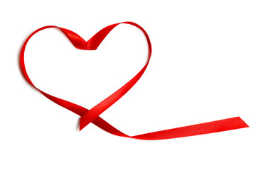 Closeup red satin ribbon or tape in heart shape, isolated on white background. Concept Valentine's Day, wedding anniversary, honeymoon, newlyweds, lovers