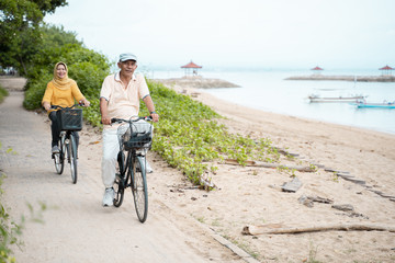 old couple ride bicycle together
