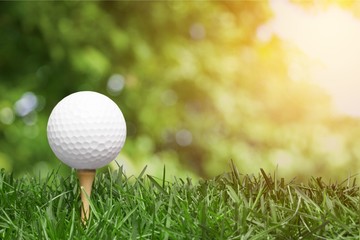 golf ball with a golf tee on a grass