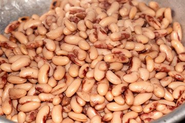 Beans, soybeans prepared in aluminum bowl, simple rustic food. Vegetarian healthy food concept.
