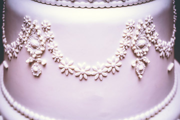 High confectionery cake decoration served at wedding receptions. Vintage style for weddings, birthdays.
