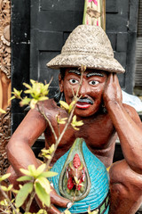 Balinese statue of rice field worker, tropical island of Bali, Indonesia.