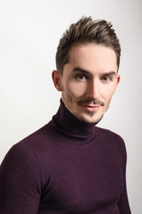 Handsome young elegant man in violet golf.