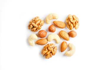Isolated nuts pattern background. Walnut, cashew, almond and hazelnut on white background. View from above.