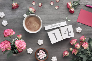 Valentines day background with pink roses, wooden calendar, greeting card and decorations, flat lay