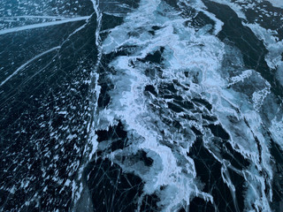 View of the frozen Lake Baikal in winter from drone. Ice cracks on lake. Abraham Lake, Lake...