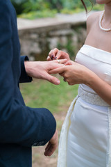 bride puts a ring on the groom's finger