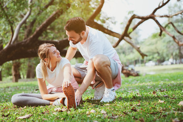 Naklejka na ściany i meble Caucasian Couples are sitting and relaxing, exercising in the garden in the morning of summer with good weather. Suitable for doing various activities That builds family love relationships
