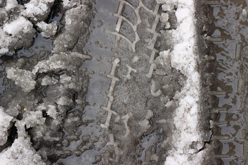 Melting snow asphalt slush water flow puddle dirty street sidewalk