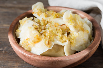 Dumplings in a wooden plate. Rustic style