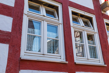 Fototapeta premium Two windows on the facade of ancient half-timbered house