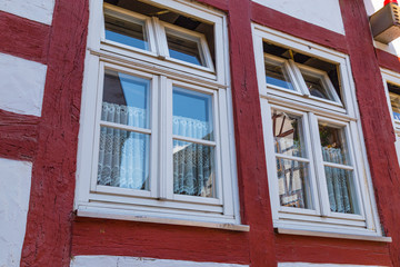 Two windows  on the facade  of  ancient half-timbered  house