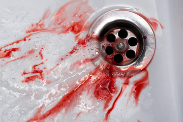 Flowing blood in the sink. Murder concept background