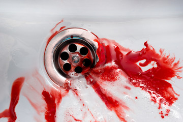 Flowing blood in the sink. Murder concept background