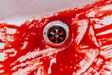 Flowing blood in the sink. Murder concept background