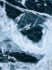 View of the frozen Lake Baikal in winter from drone. Ice cracks on lake. Abraham Lake, Lake...