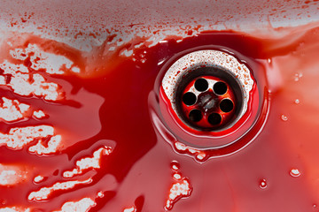 Flowing blood in the sink. Murder concept background