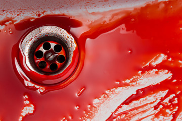 Flowing blood in the sink. Murder concept background
