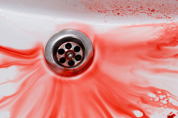 Flowing blood in the sink. Murder concept background