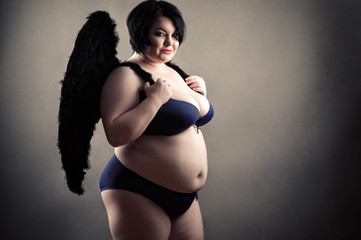 charming fat woman in fashionable lingerie with black wings