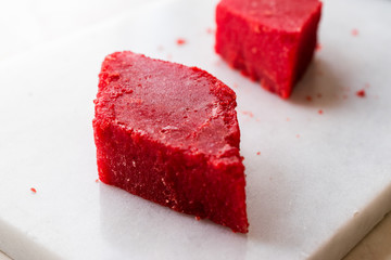 Crystallized Turkish Delight Red Sugar. Crystal Confectionery Nobet Sekeri on White Marble Surface.