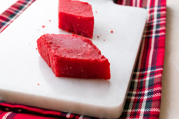 Crystallized Turkish Delight Red Sugar. Crystal Confectionery Nobet Sekeri on White Marble Surface.