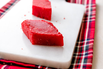 Crystallized Turkish Delight Red Sugar. Crystal Confectionery Nobet Sekeri on White Marble Surface.